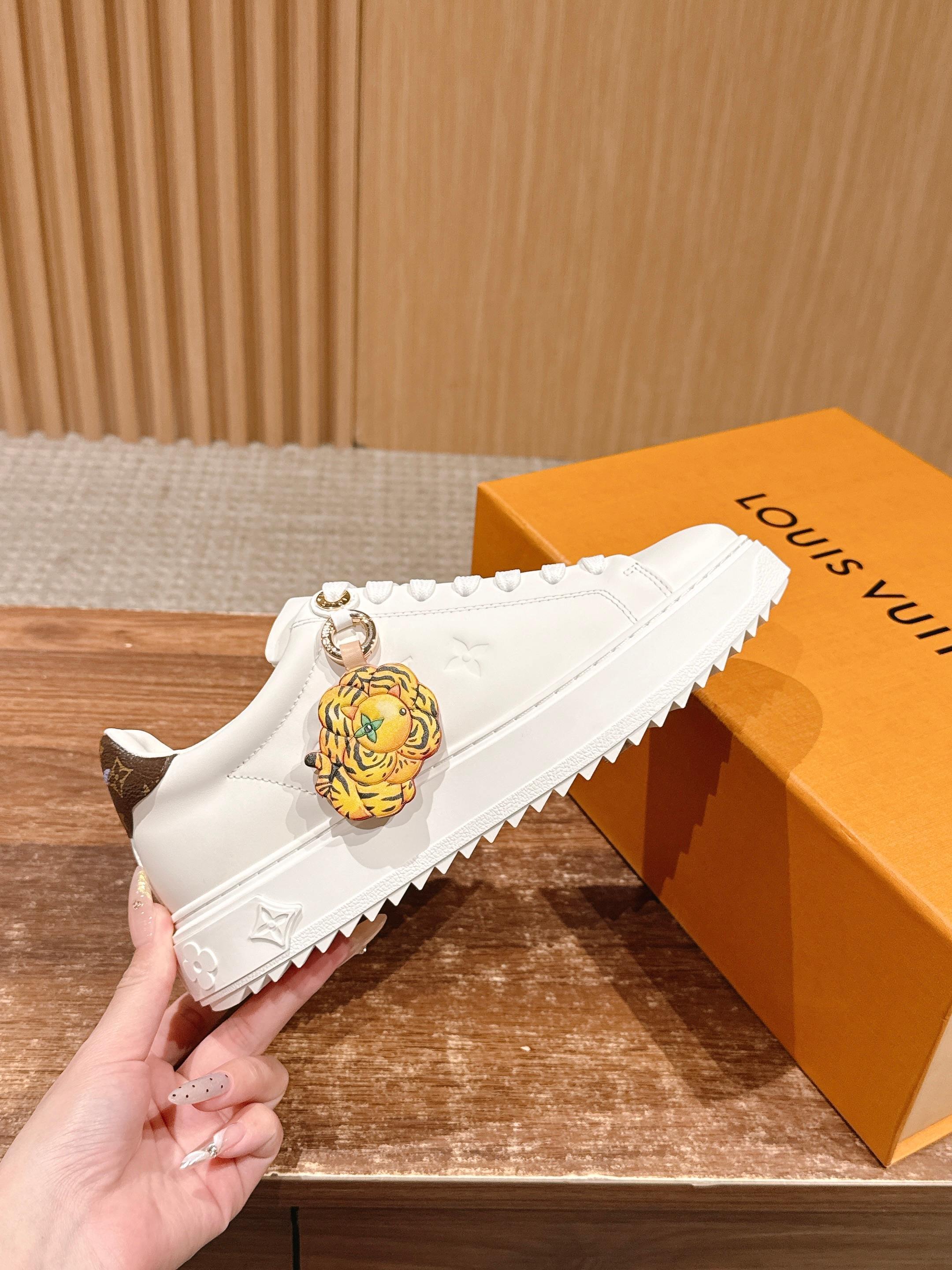 Louis Vuitton Women's White Leather Sneakers with Gold Accents