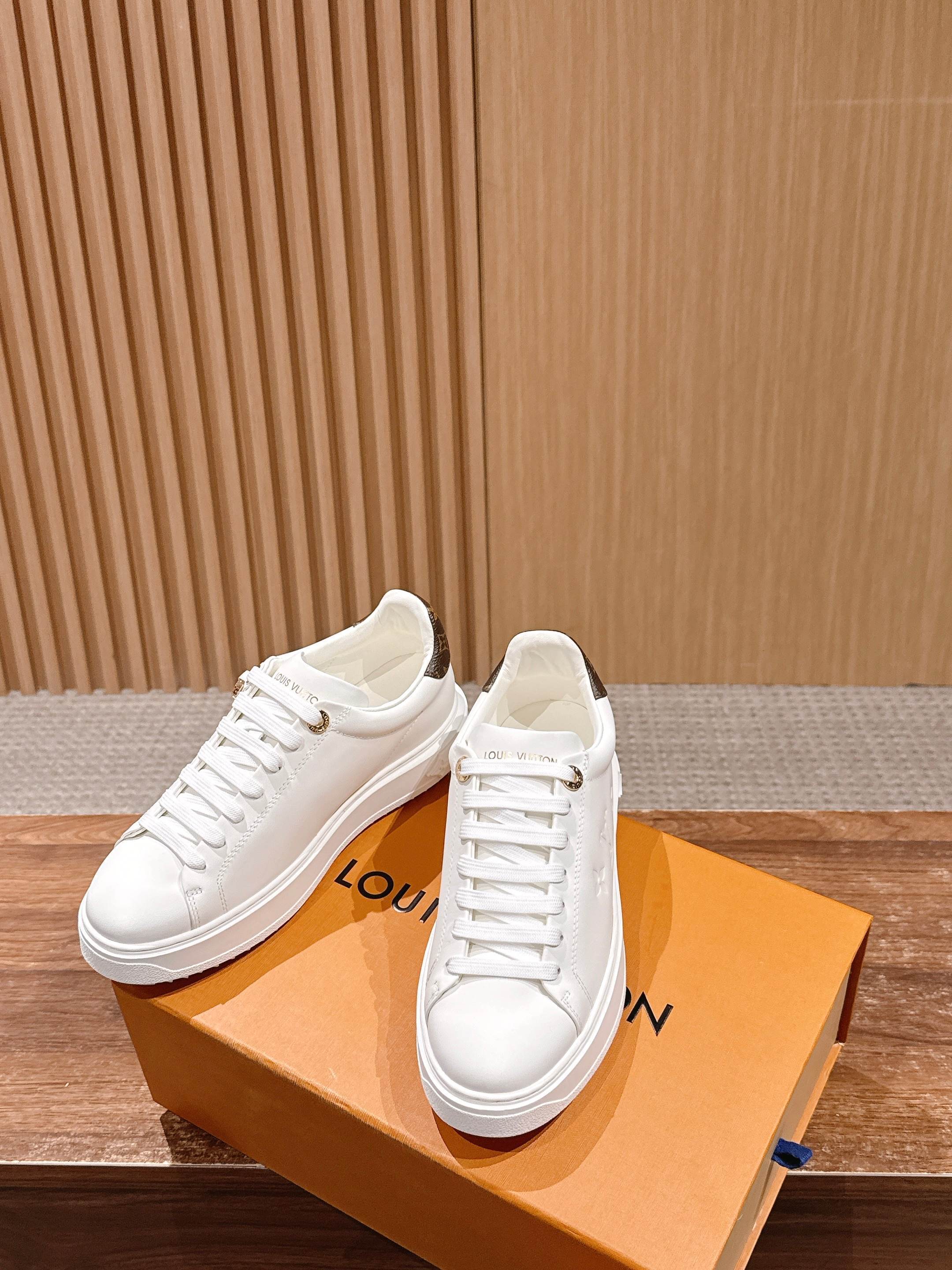Louis Vuitton Women's White Leather Sneakers with Gold Accents