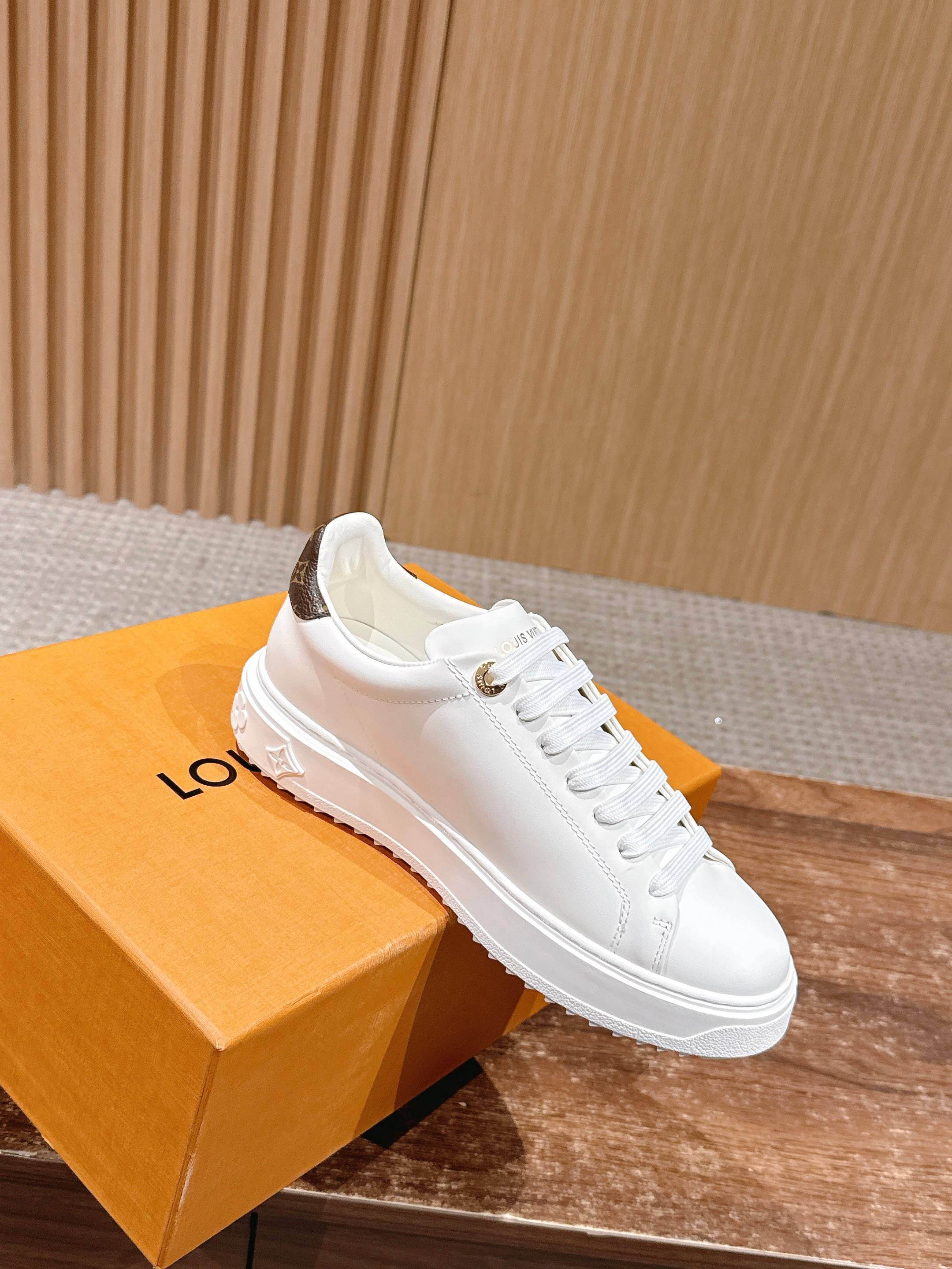 Louis Vuitton Women's White Leather Sneakers with Gold Accents