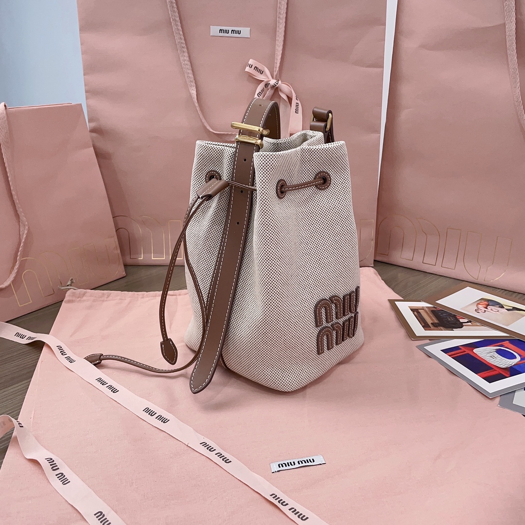Logo leather-trimmed bucket bag in beige - Miu Miu