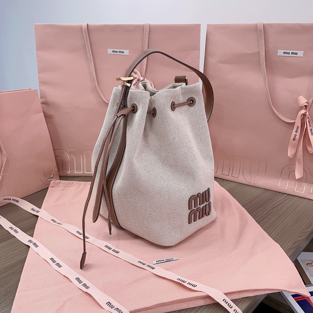 Miu Miu Logo leather-trimmed bucket bag in beige - Miu Miu |