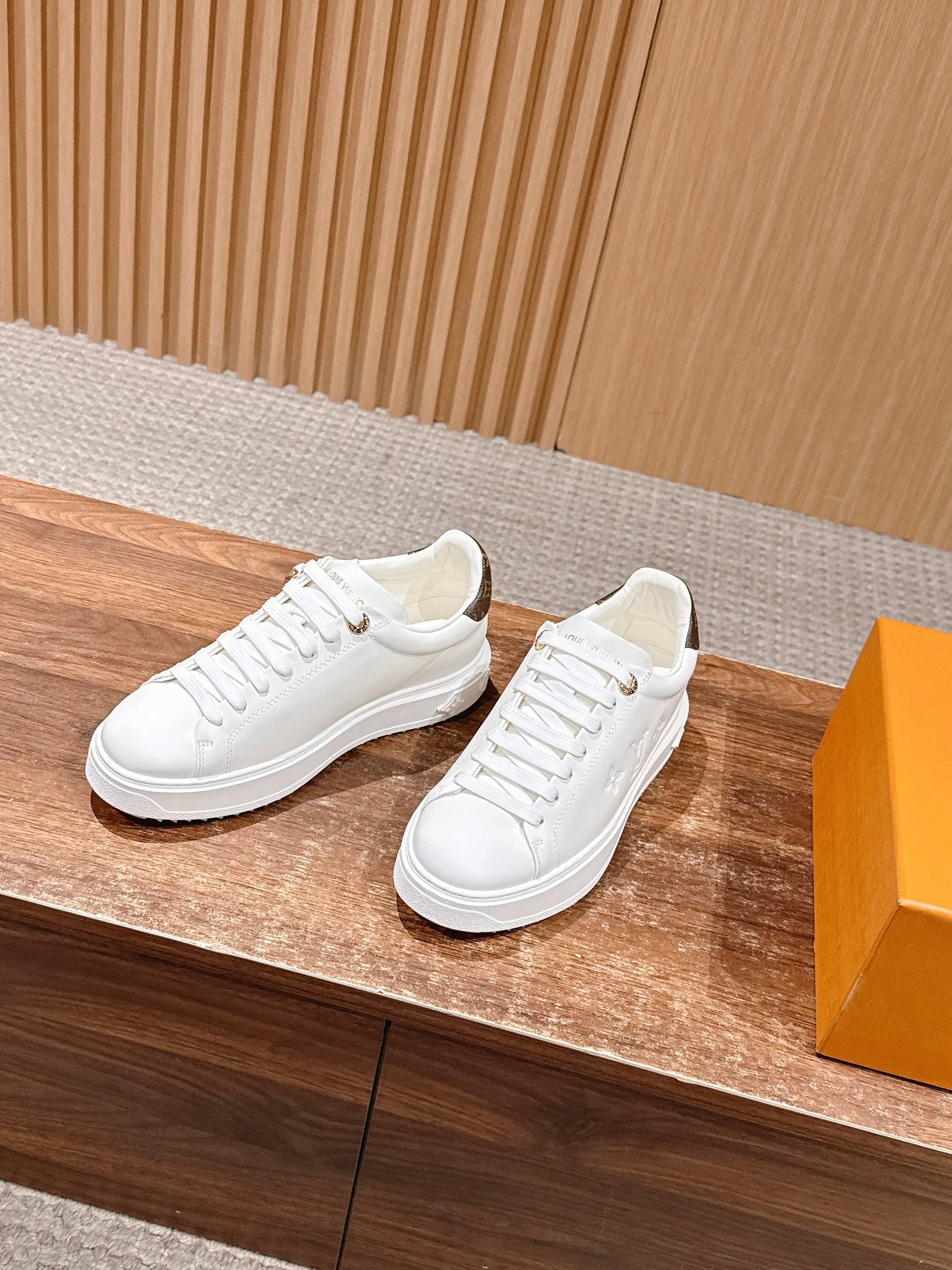 Louis Vuitton Women's White Leather Sneakers with Gold Accents