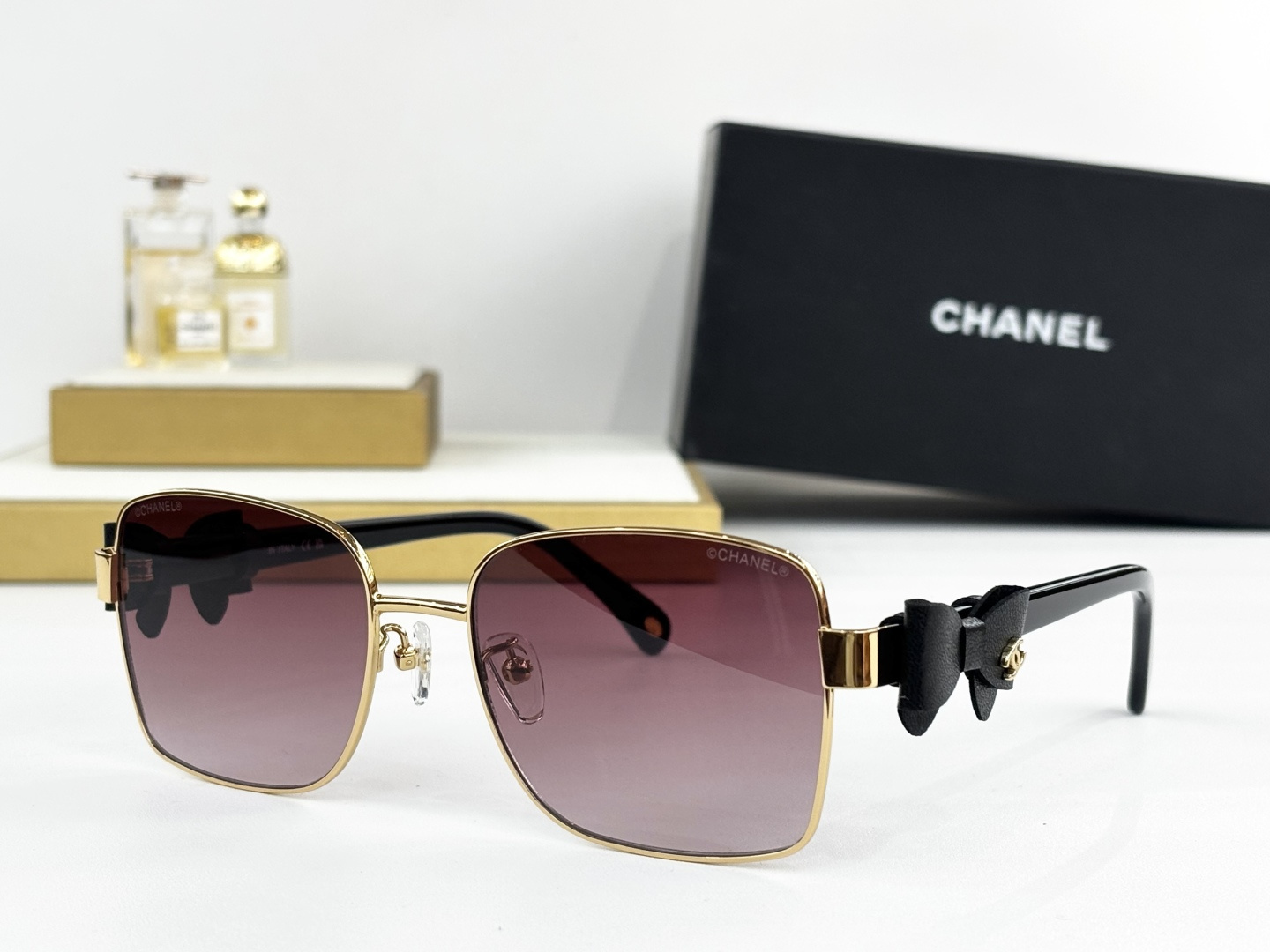 Luxury Chanel Gold Metal Sunglasses with Leather Bow & CC Logo