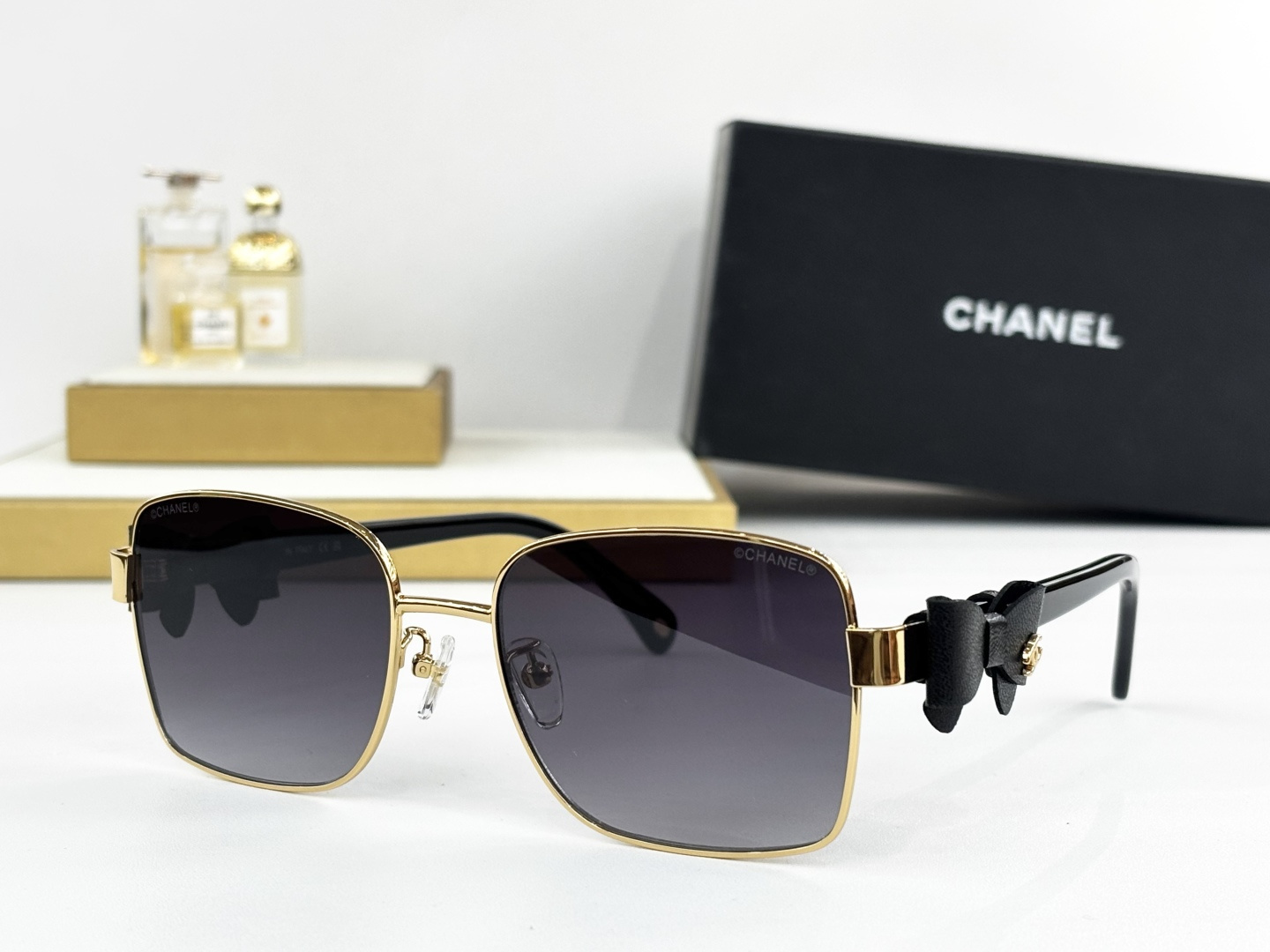 Luxury Chanel Gold Metal Sunglasses with Leather Bow & CC Logo
