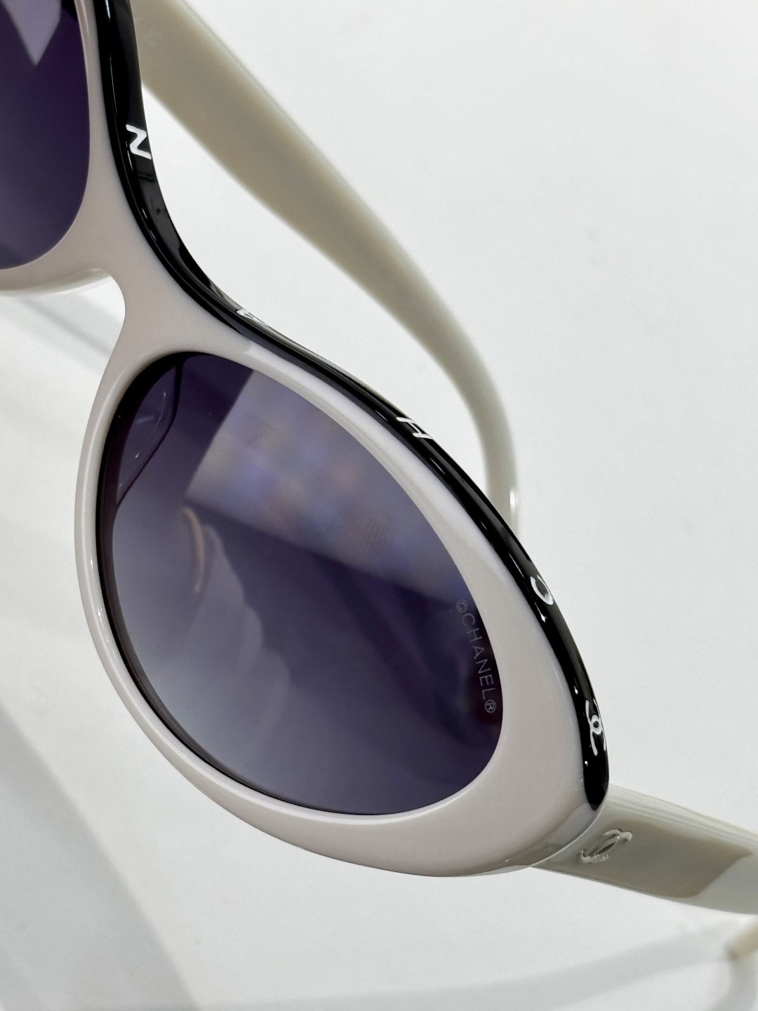Chanel Luxury Oval Sunglasses – White Acetate with Black Logo Rim