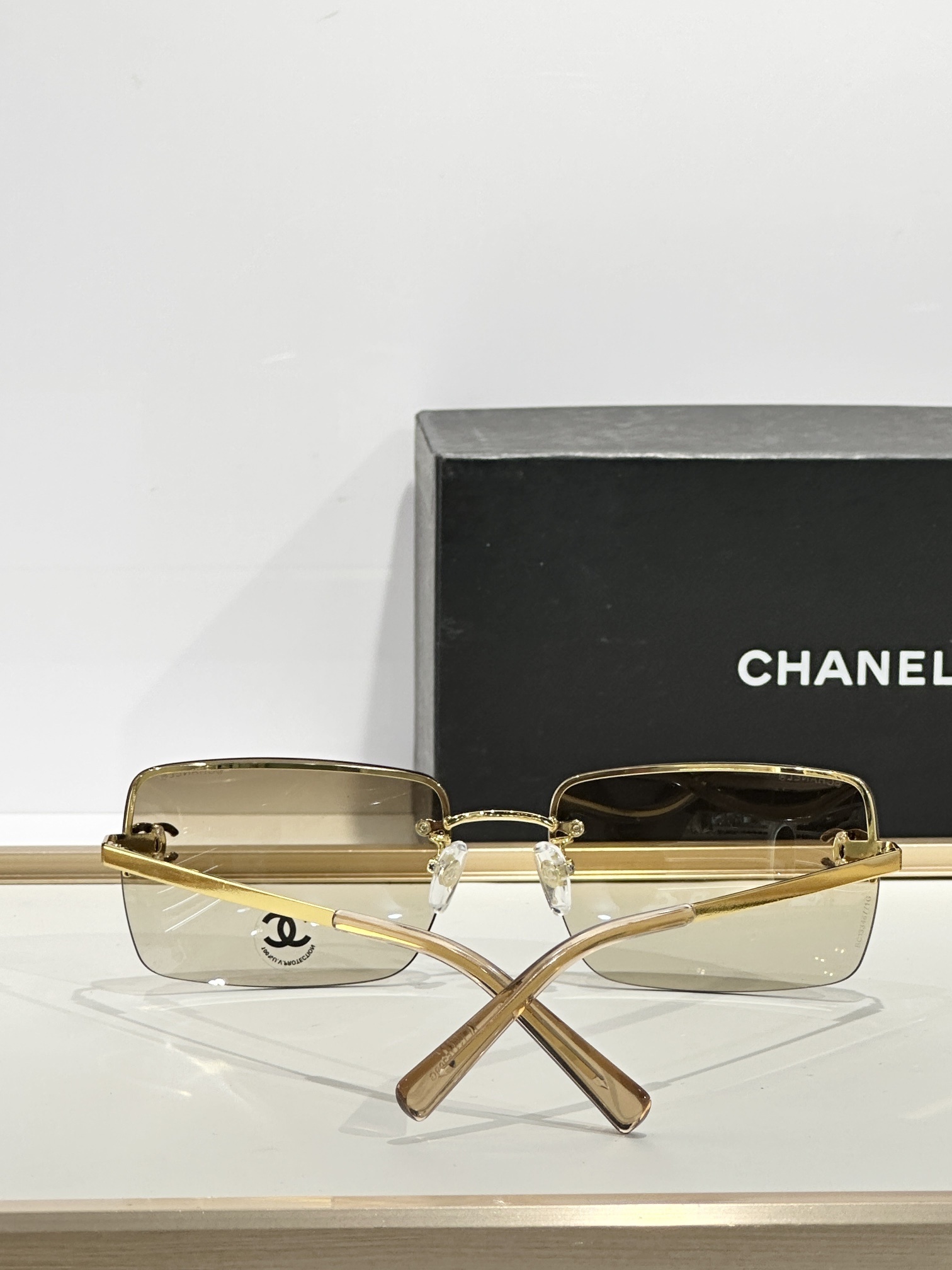 Chanel Luxury Rimless Sunglasses with Crystal CC Logo & Brown Lenses