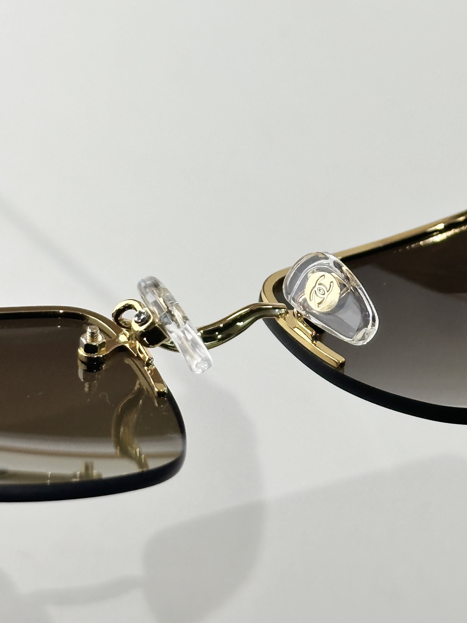 Chanel Luxury Rimless Sunglasses with Crystal CC Logo & Brown Lenses