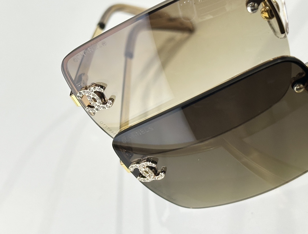 Chanel Luxury Rimless Sunglasses with Crystal CC Logo & Brown Lenses