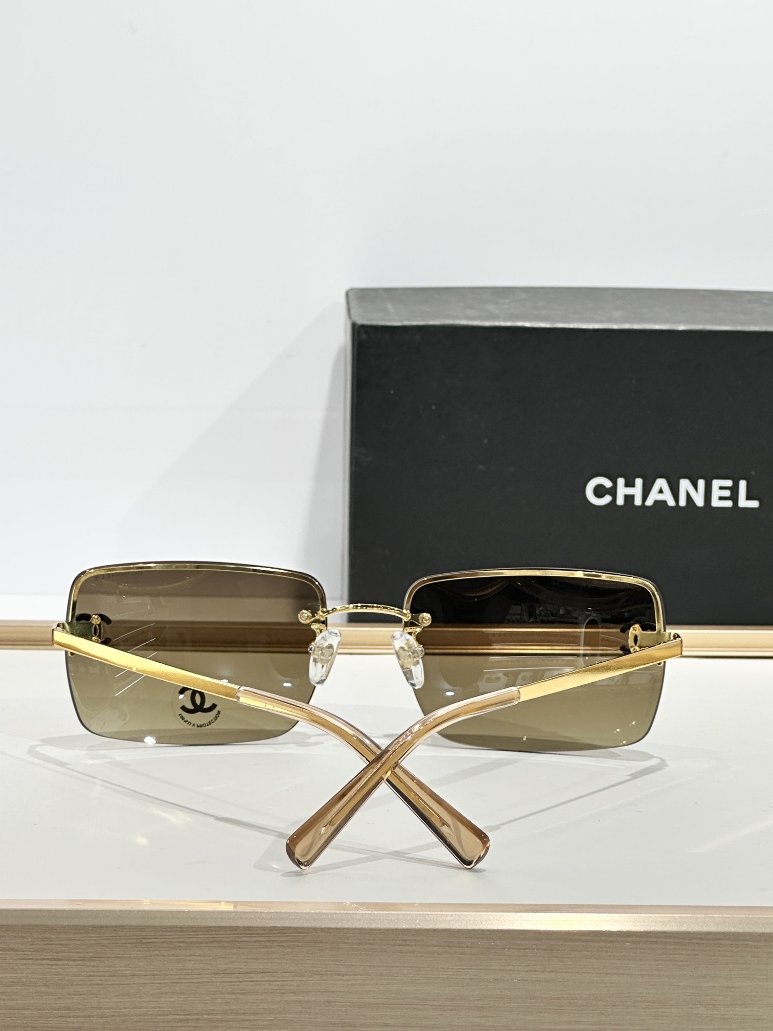 Chanel Luxury Rimless Sunglasses with Crystal CC Logo & Brown Lenses