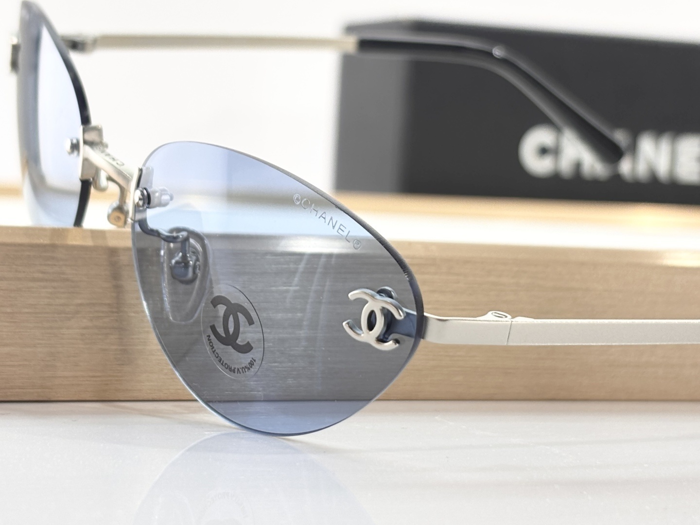 Chanel Luxury Rimless Sunglasses – Blue Tinted Lenses & Silver Logo