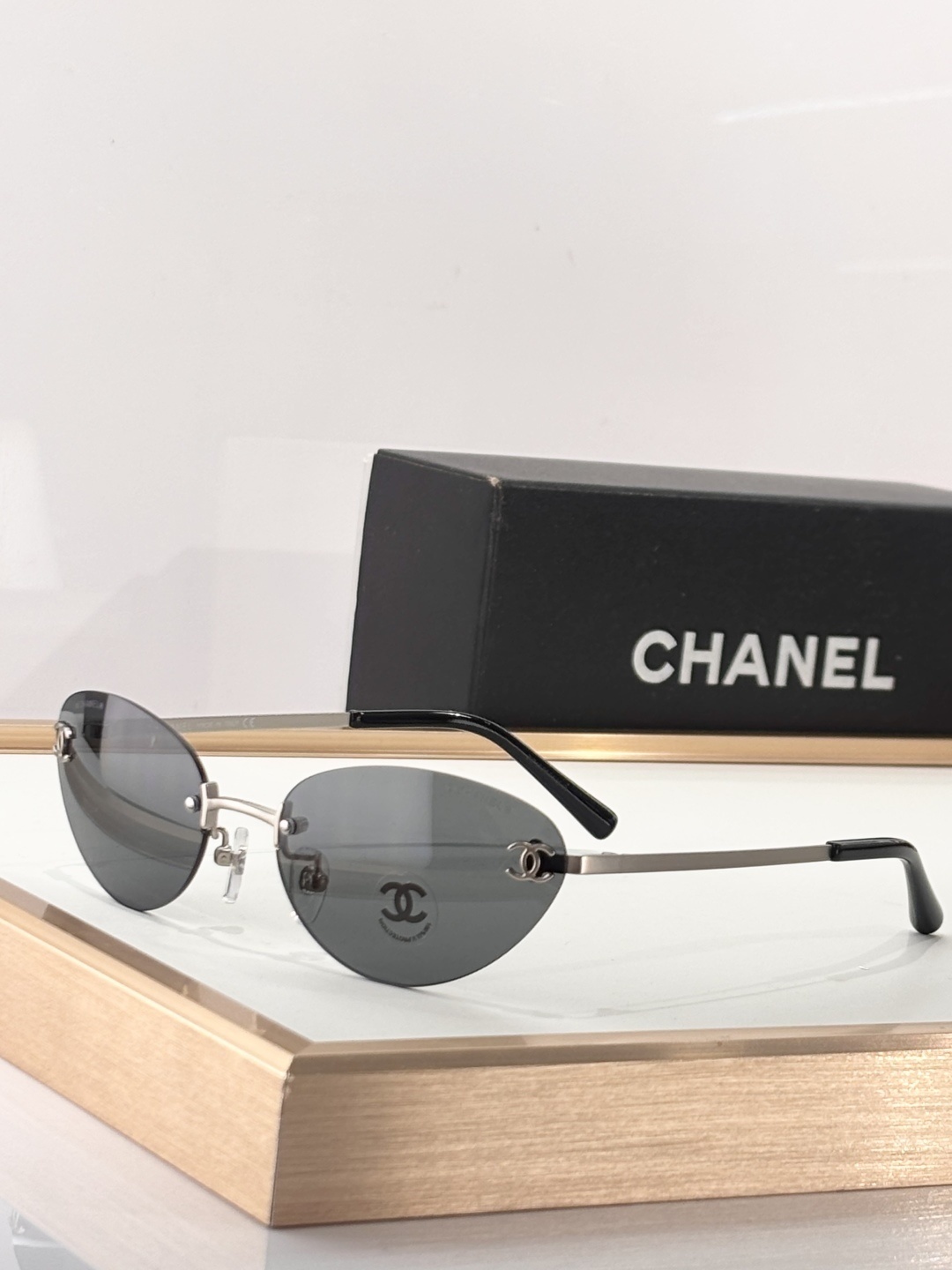Chanel Luxury Rimless Sunglasses – Blue Tinted Lenses & Silver Logo