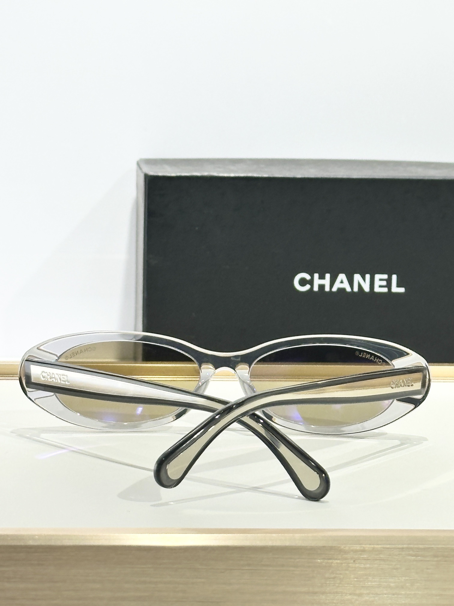Chanel Oval Sunglasses – Transparent Grey Frame & Gold Mirror Lens