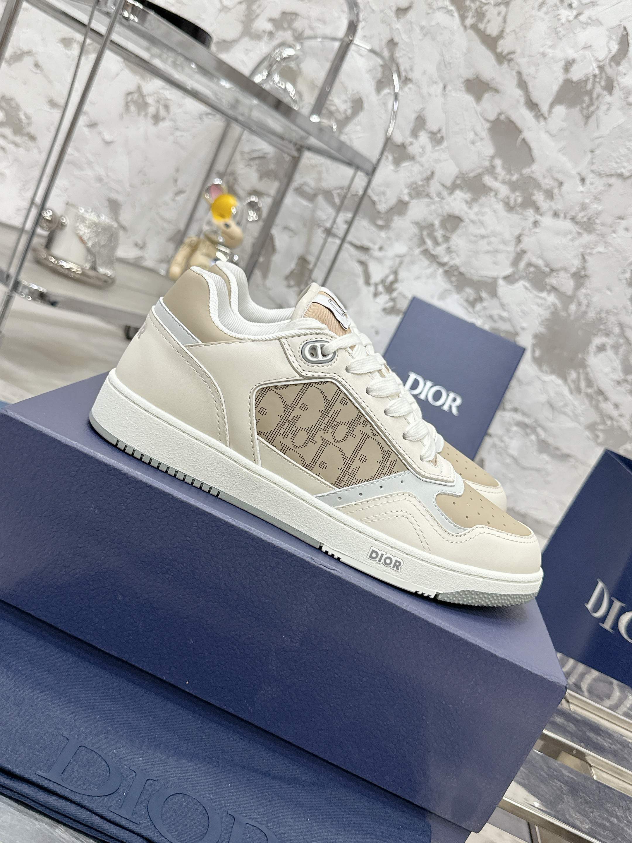 Dior B27 Low-Top Sneaker in beige and white leather with Dior Oblique Galaxy inserts and CD Icon signature.