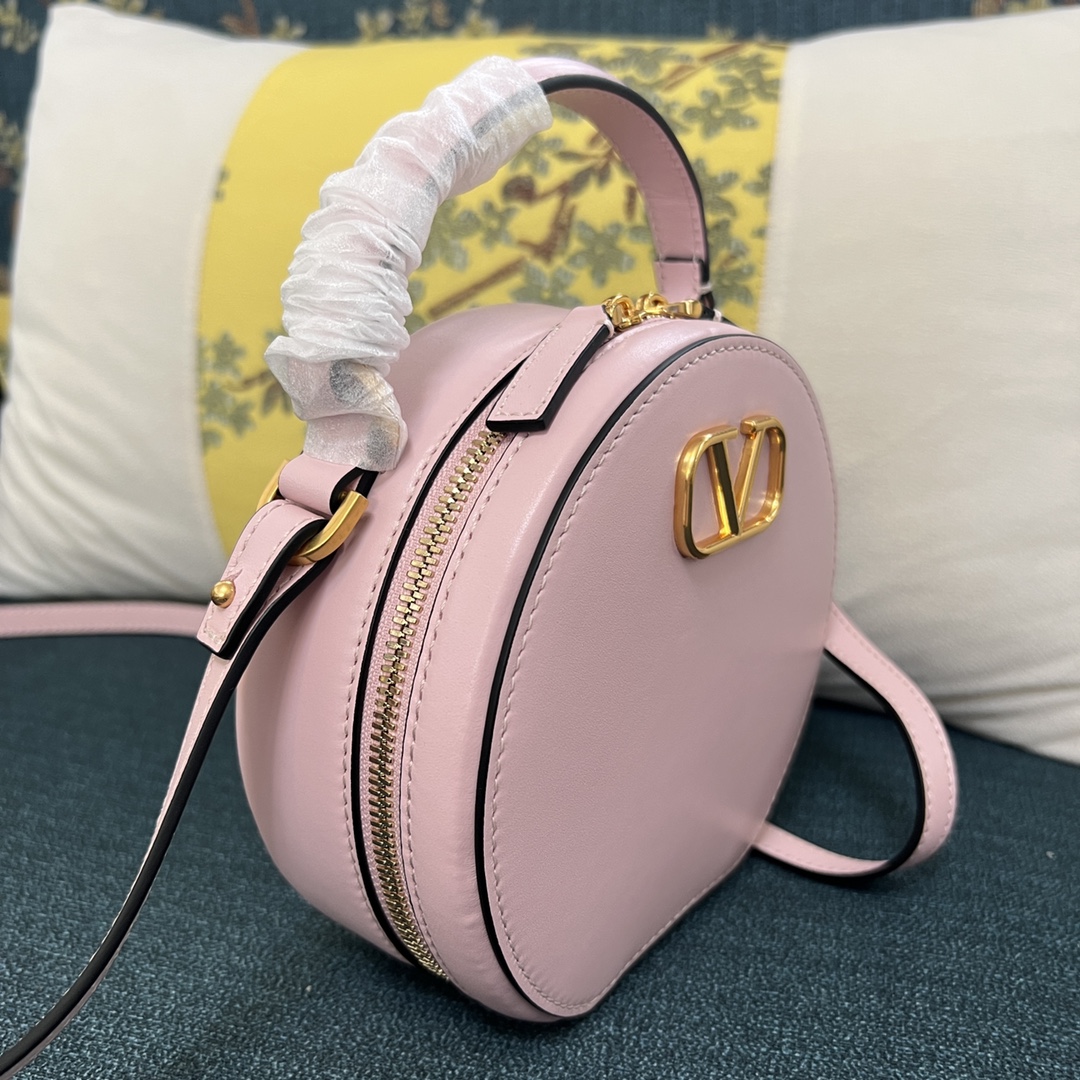 Valentino Garavani Vlogo Round Crossbody Bag in Pastel Pink